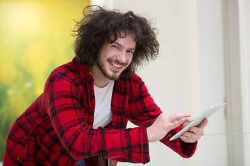 Image showing young freelancer using tablet computer