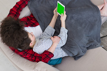 Image showing couple relaxing at  home with tablet computers