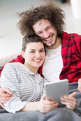 Image showing couple relaxing at  home with tablet computers