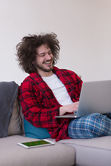 Image showing man freelancer in bathrobe working from home