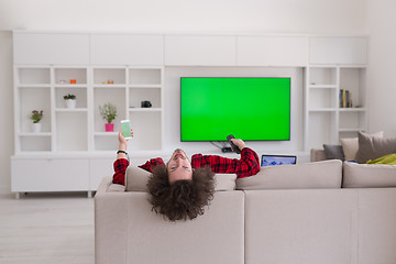 Image showing young man in bathrobe enjoying free time