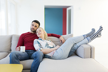 Image showing couple hugging and relaxing on sofa