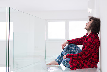 Image showing young freelancer in bathrobe working from home