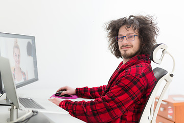 Image showing graphic designer in bathrobe working at home