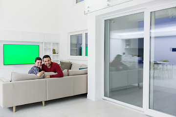 Image showing couple hugging and relaxing on sofa