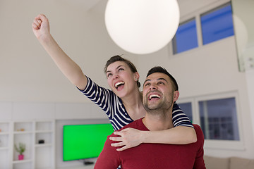 Image showing handsome man piggybacking his girlfriend