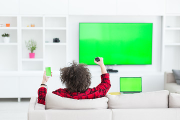 Image showing young man in bathrobe enjoying free time