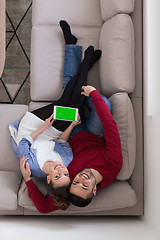 Image showing couple relaxing at  home with tablet computers