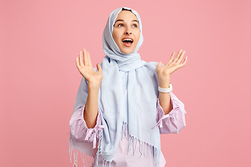 Image showing Happy arab woman in hijab. Portrait of smiling girl, posing at studio background