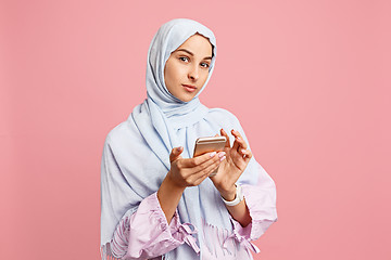 Image showing Happy arab woman in hijab. Portrait of smiling girl, posing at studio background