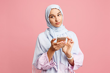 Image showing Happy arab woman in hijab. Portrait of smiling girl, posing at studio background