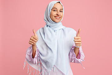 Image showing Happy arab woman in hijab. Portrait of smiling girl, posing at studio background