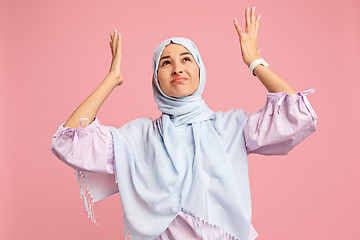 Image showing Argue, arguing concept. arab woman in hijab. Portrait of girl, posing at studio background