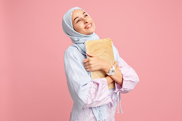 Image showing Happy arab woman in hijab. Portrait of smiling girl, posing at studio background