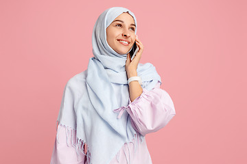 Image showing Happy arab woman in hijab. Portrait of smiling girl, posing at studio background