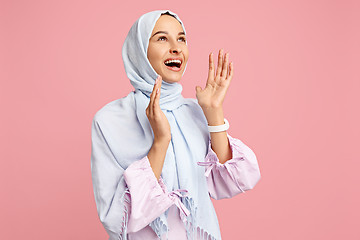 Image showing Happy arab woman in hijab. Portrait of smiling girl, posing at studio background