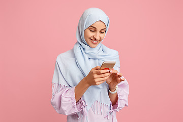 Image showing Happy arab woman in hijab. Portrait of smiling girl, posing at studio background