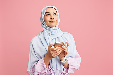 Image showing Happy arab woman in hijab. Portrait of smiling girl, posing at studio background