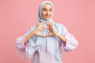 Image showing Happy arab woman in hijab. Portrait of smiling girl, posing at studio background