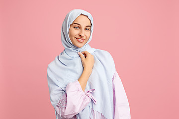 Image showing Happy arab woman in hijab. Portrait of smiling girl, posing at studio background