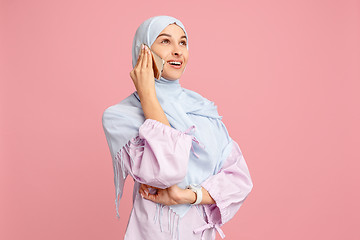 Image showing Happy arab woman in hijab. Portrait of smiling girl, posing at studio background