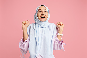 Image showing Happy arab woman in hijab. Portrait of smiling girl, posing at studio background