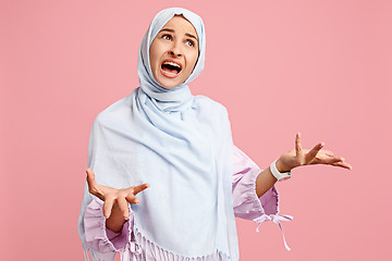 Image showing Argue, arguing concept. arab woman in hijab. Portrait of girl, posing at studio background