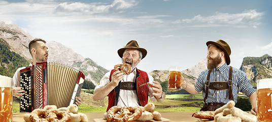 Image showing Germany, Bavaria, Upper Bavaria, men with beer dressed in traditional Austrian or Bavarian costume
