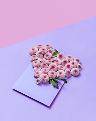 Image showing Handmade envelope with flowers heart on a duotone pastel background.