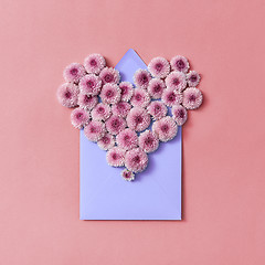 Image showing Hardy chrysanthemums heart with envelope for post card on a pastel background.