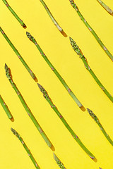 Image showing Natural organic asparagus pattern on an yellow background.