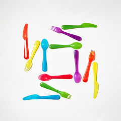 Image showing Colorful pattern from plastic eating utensil on a grey background.