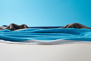 Image showing Seascape with rocks made from blue towels on a sky background.