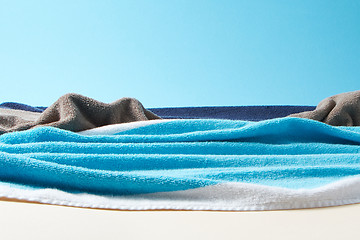 Image showing Coastline with waves and stones made from towels on a paper background