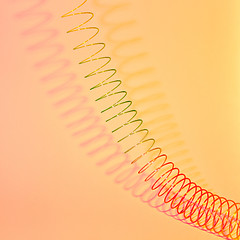 Image showing Stretching rainbow plastic spring toy with shadows.