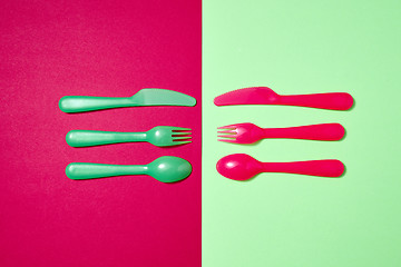 Image showing Colorful pattern from plastic eating utensil on a duotone background.