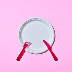 Image showing Dining set served fork and knife on pink.