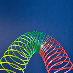 Image showing Geometric parabola from colored slinky toy.