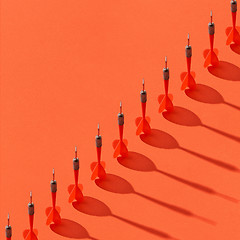 Image showing Diagonal line of darts with shadows.