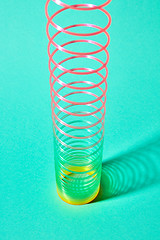 Image showing Stretching plastic colored spring with shadows shadows