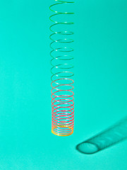 Image showing Hunging colorful plastic spiral with shadows.