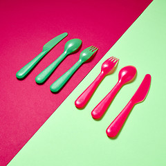 Image showing Kids plastic colorful cutlery on a duotone background.