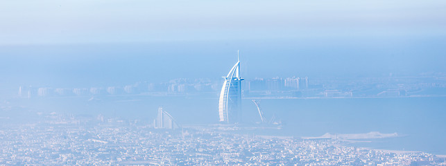 Image showing Skyline of Dubai beachfront with Burj Al Arab hotel on Jumeirah beach seen from Burj Khalifa viewpoint.