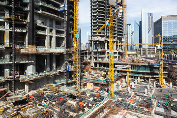 Image showing Laborers working on modern constraction site works in Dubai. Fast urban development consept