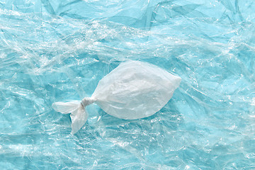 Image showing Fish made from plastic bag on a transparent polyethylene background.