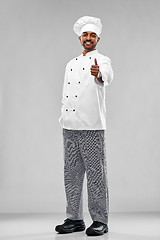 Image showing happy male indian chef in toque showing thumbs up