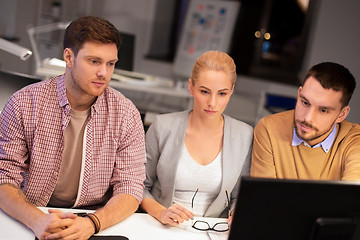 Image showing business team with computer working late at office