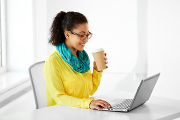 Image showing creative woman with coffee and laptop at office