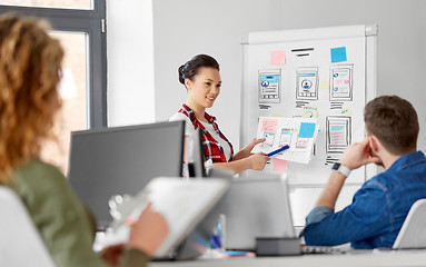 Image showing creative woman showing user interface at office