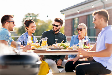 Image showing happy friends having bbq party on rooftop